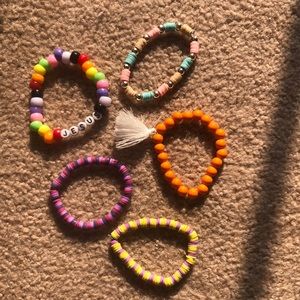 5 bracelets, all have a stretchy band.